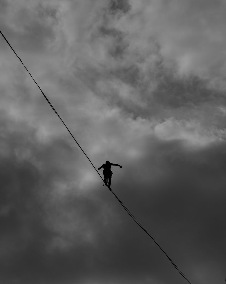 A tightrope walker balances against a cloudy sky. This could represent the fears a trauma therapist in Sacramento, CA can help you address. Contact us to learn about therapy in Pasadena, CA and other services. An online therapist in California would be happy to support you! 95624 | 95687 | 95762