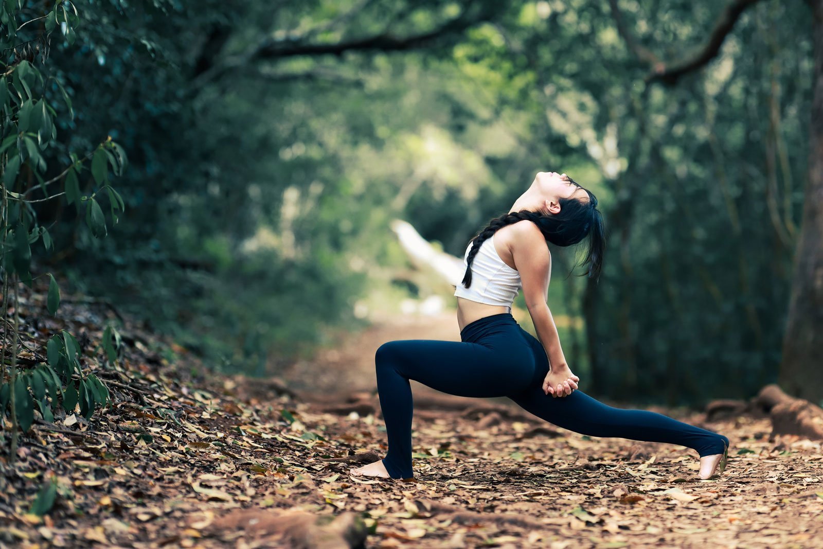 A woman practices yoga in a leaf covered forest. This could represent the power of somatic therapy in Pasadena, CA. For more information on how somatic experiencing therapy can help, contact a somatic therapist today 91101 | 90026 | 90042 | 90065