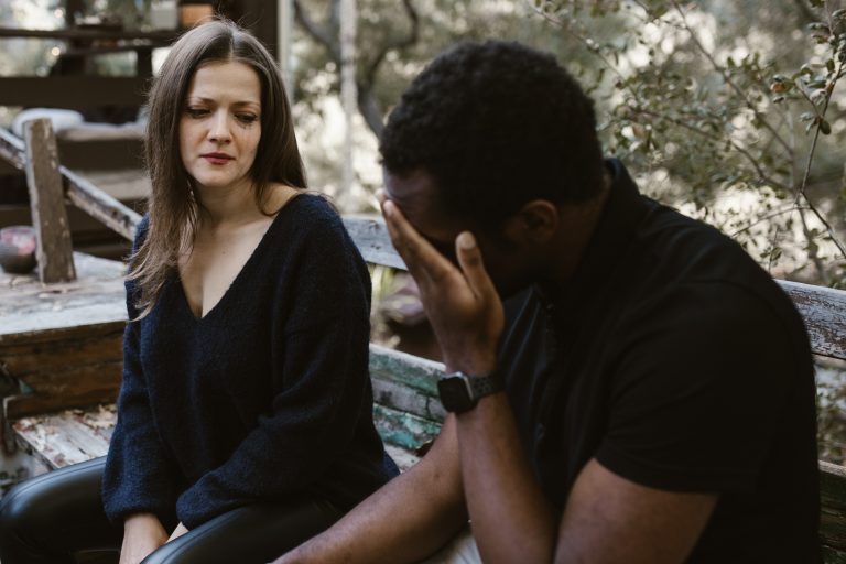 A man hides his face in his hands as his partner watches. Affair recovery in Pasadena, CA can help your relationship recover after an affair. Learn more from an affair recovery therapist in Sacramento, CA for more information. 95814 | 95688 | 95765