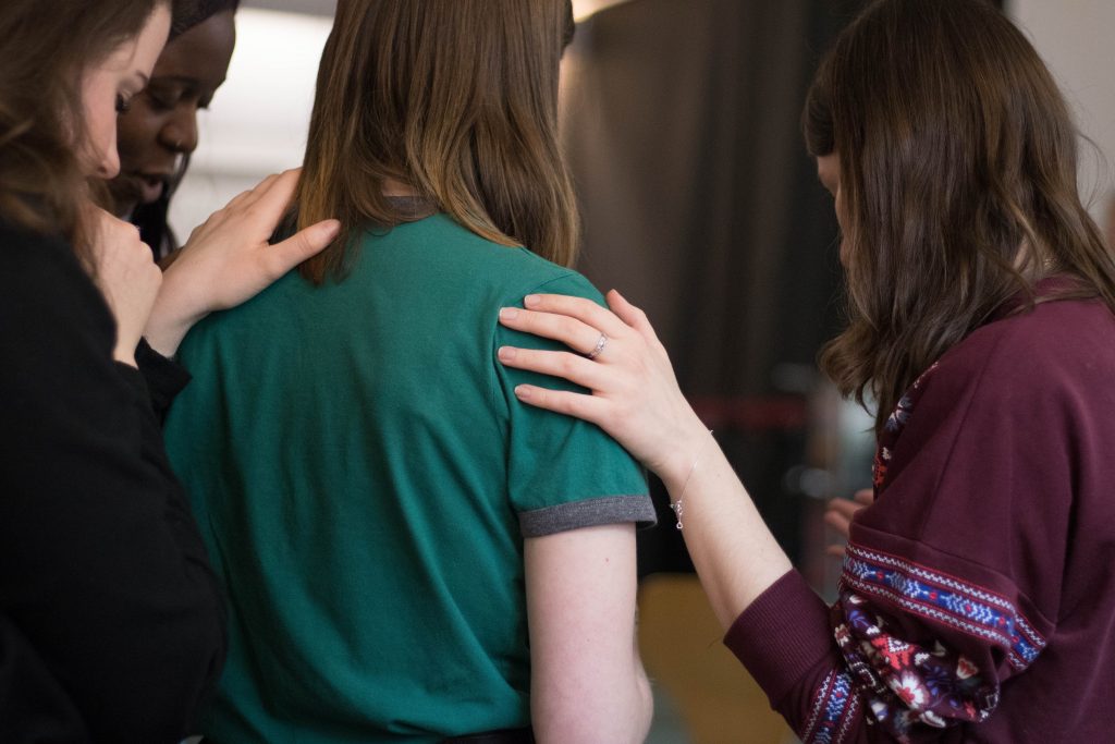 Two friends place a hand on the shoulder of another to comfort them. Group therapy in Pasadena, CA can provide similar support at Body Mind Psychology with Chris Tickner, LMFT. Contact us & learn about group trauma therapy in Pasadena, CA and other services.