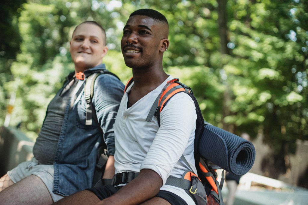 A gay couple camps together finding solace and calm in nature. Connect with a Couples Therapist in Pasadena, CA for more ideas to strengthen your relationship.